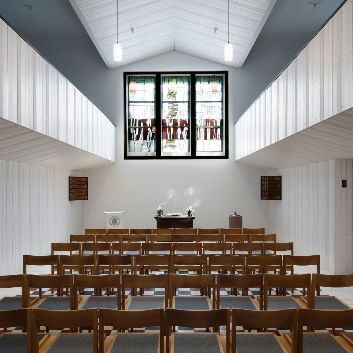 Interior of the renovated Christ Church in Bruchhof-Sanddorf with modern furnishings and lighting – an example of contemporary sacred architecture.